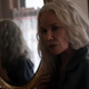 Barbara Hershey has long grey hair and is reflected in an oval mirror in a scene from The Manor.